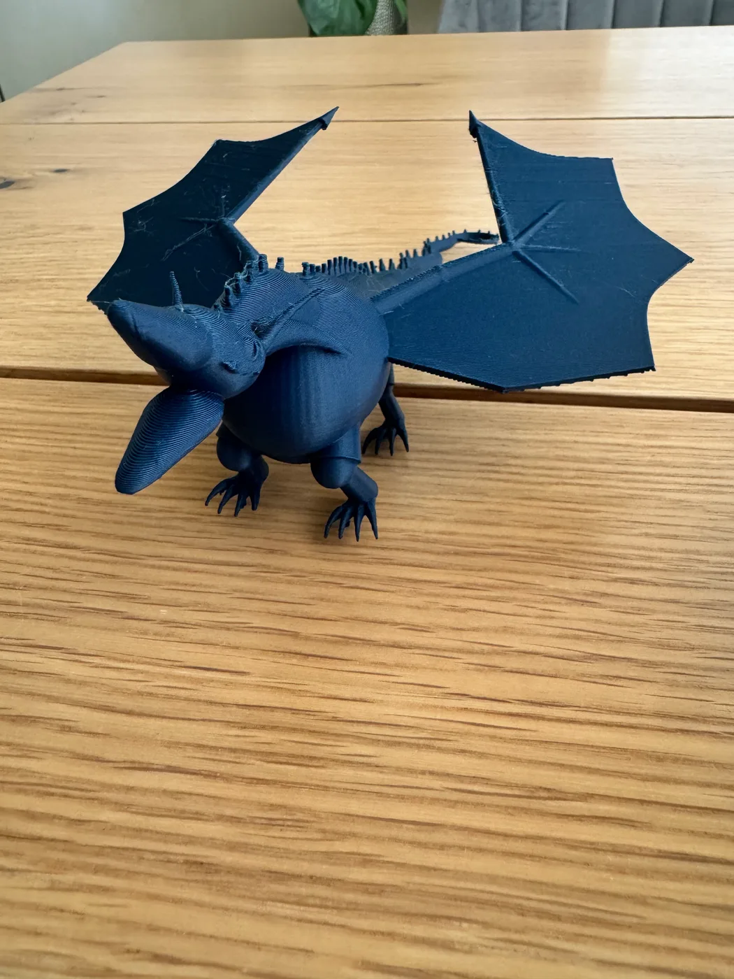 A matte PLA Shadow Wing dragon is shown with large fantasy wyvern wings, a long tail and procedural design details.
